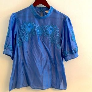 Pretty blue Anthropologie top with decorative design